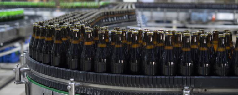 The production of beer that is marketed through contract manufacturing agreements